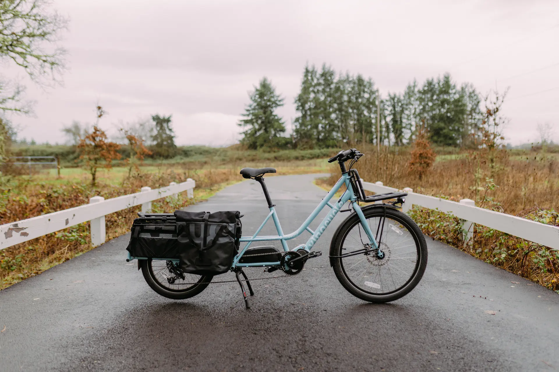 Xtracycle Swoop long-tail electric cargo bike on a pathway in the country